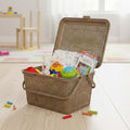 GoHooked BIANCO light brown plastic picnic storage basket with lid, handle, and snap lock, filled with toys and diapers.