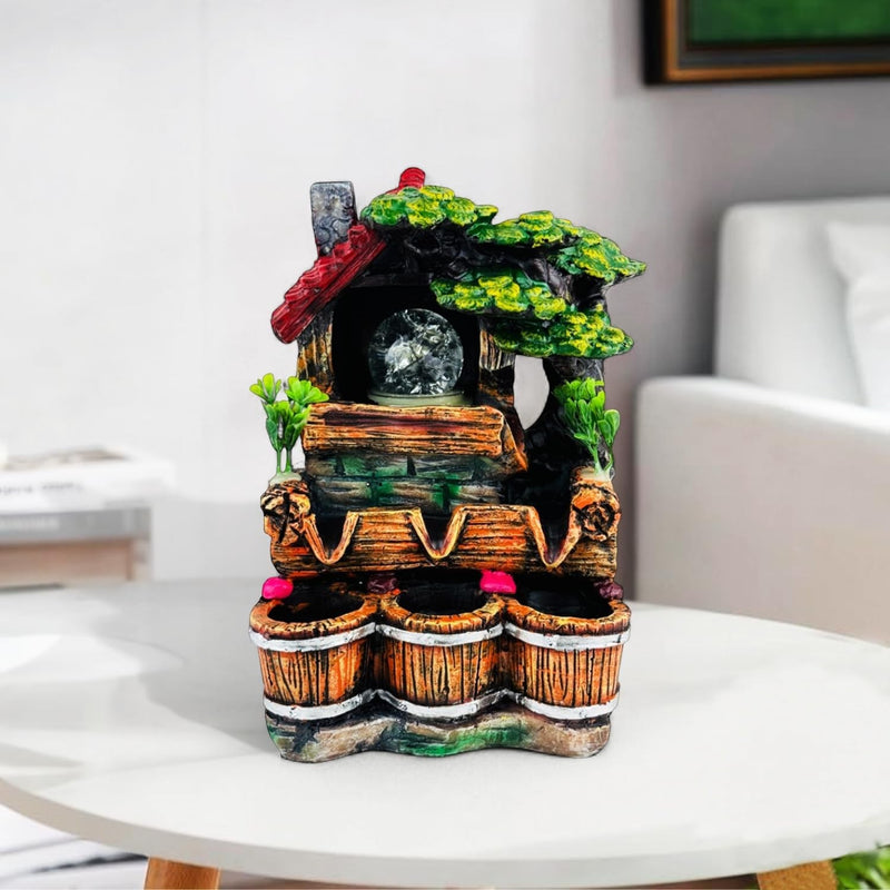 GoHooked BIANCO polyresin tabletop waterfall fountain with LED lights and adjustable speed, featuring a rustic house and tree design with three wooden buckets.