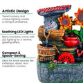 GoHooked BIANCO polyresin tabletop waterfall fountain with LED lights and sunflowers. Features tiered rockery, wooden buckets, and a red water wheel.