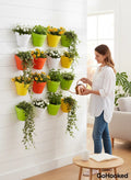 Go Hooked Bianco wall hanging pot set in multicolor, made of polypropylene plastic. Set of 12 pots with plants.