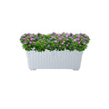 GoHooked Bianco white rectangular plastic planter with fluted sides, filled with lush green foliage and purple flowers.