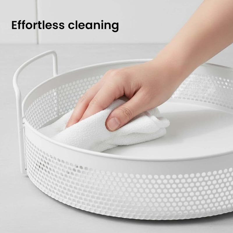 GoHooked Bianco white round metal storage tray with perforated sides and side handles, being wiped clean.
