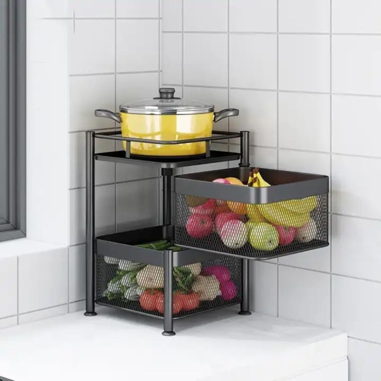 GoHooked black 2-layer rotating kitchen trolley organizer with mesh baskets holding fruits and vegetables, and a pot on top.