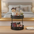 Go Hooked black 2-tier metal mesh countertop organizer holding makeup brushes, perfumes, and cosmetics.