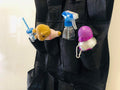 Go Hooked black 20-pocket over-the-door organizer made of non-woven fabric, holding a teddy bear, spray bottle, and water bottle.
