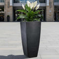 GoHooked black 26-inch tall geometric polymer planter with a peace lily plant.