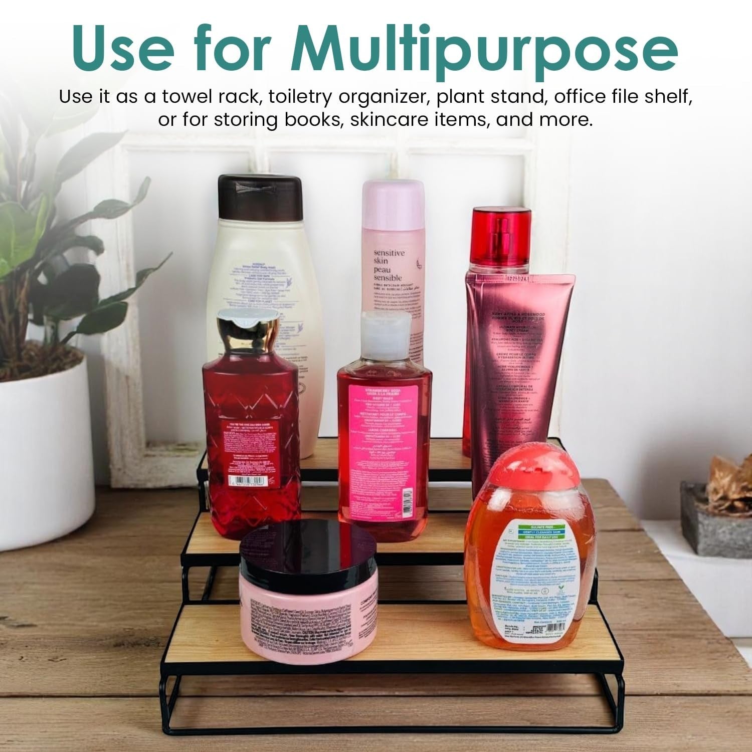 GoHooked black 3-tier iron countertop organizer rack with wood shelves holding toiletries and bottles.
