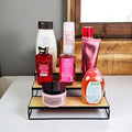 GoHooked black 3-tier iron countertop organizer rack with wood shelves holding toiletries and bottles.
