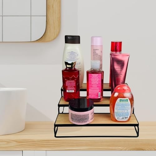 GoHooked black 3-tier wooden shelf organizer with various bottles and jars on a bathroom counter.