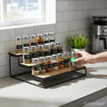 GoHooked black 3-tier wooden shelf organizer with spice jars on a kitchen counter.