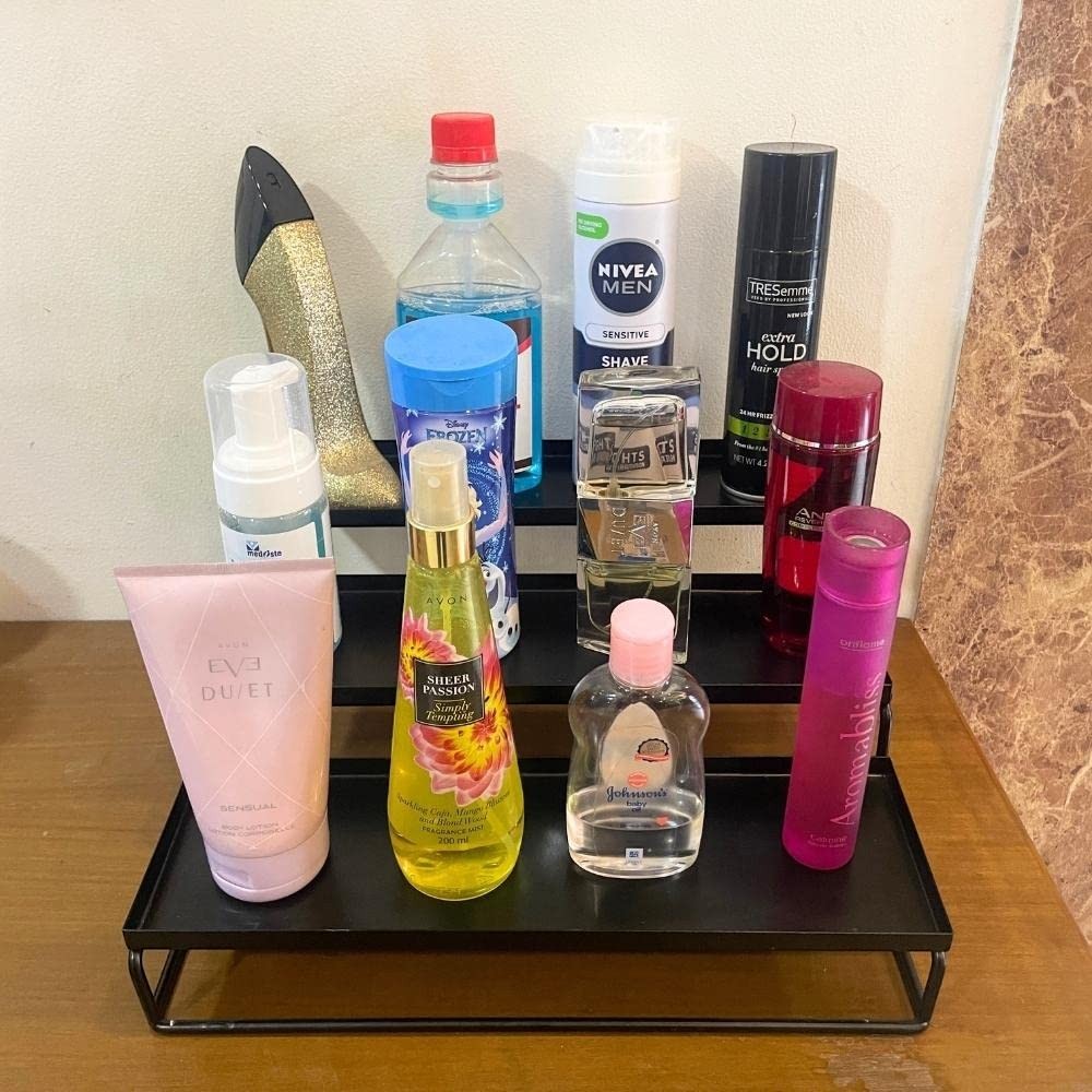 GoHooked black 3-tier metal step rack organizer holding various bottles and containers, ideal for spices or bathroom items.