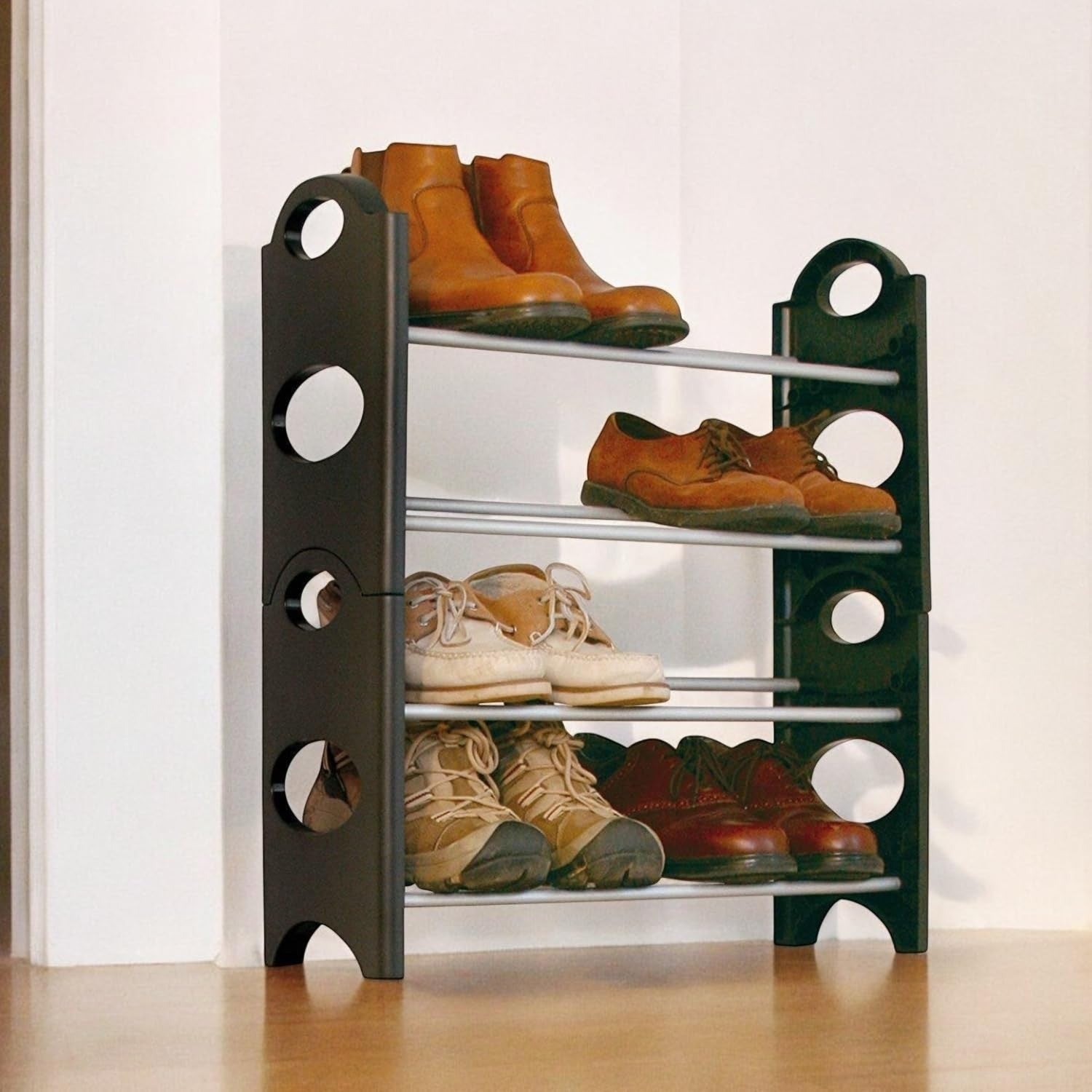 Go Hooked black 4-tier plastic shoe rack holding boots, oxfords, boat shoes, and sneakers. Space-saving design.