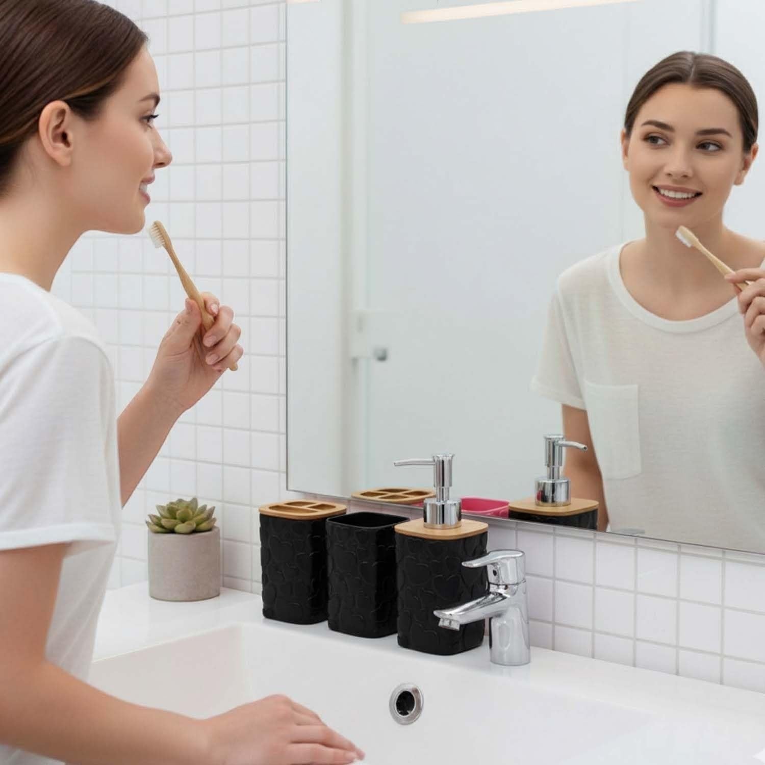 Go Hooked black plastic bathroom accessory set with heart embossed design, includes soap dispenser, toothbrush holder, tumbler, and soap dish.