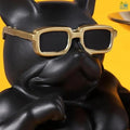 Go Hooked black polyresin bulldog statue with gold-rimmed sunglasses holding serving trays.