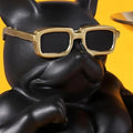 GoHooked black polyresin bulldog statue with gold-rimmed sunglasses holding two serving trays.