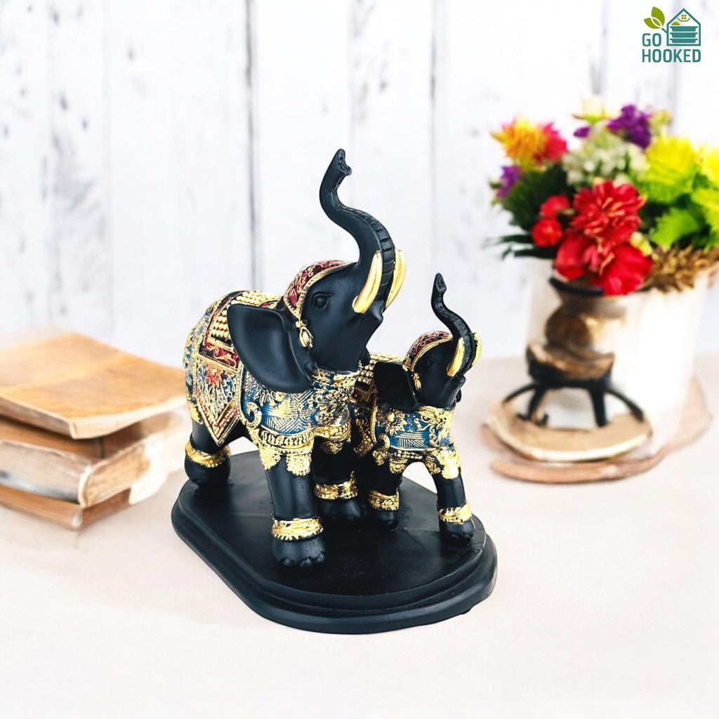 Go Hooked black polyresin elephant figurine with gold and blue royal embellishments, trunk up for good luck.