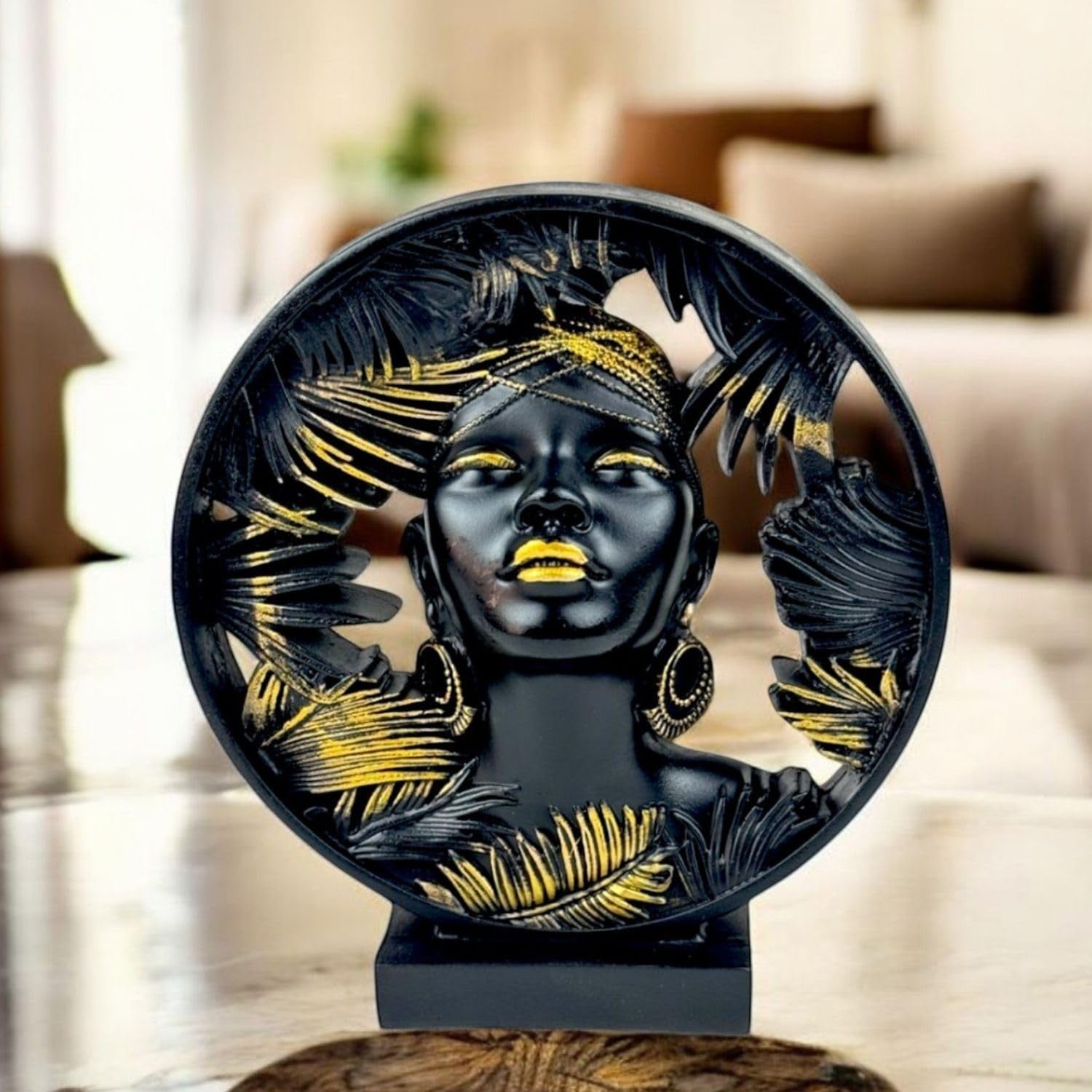 GoHooked black and gold polyresin bust statue of an African lady with palm leaf details. Luxury home decor.