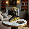 GoHooked black polyresin bust of an African woman with gold tribal leaf accents, headwrap, and earrings.