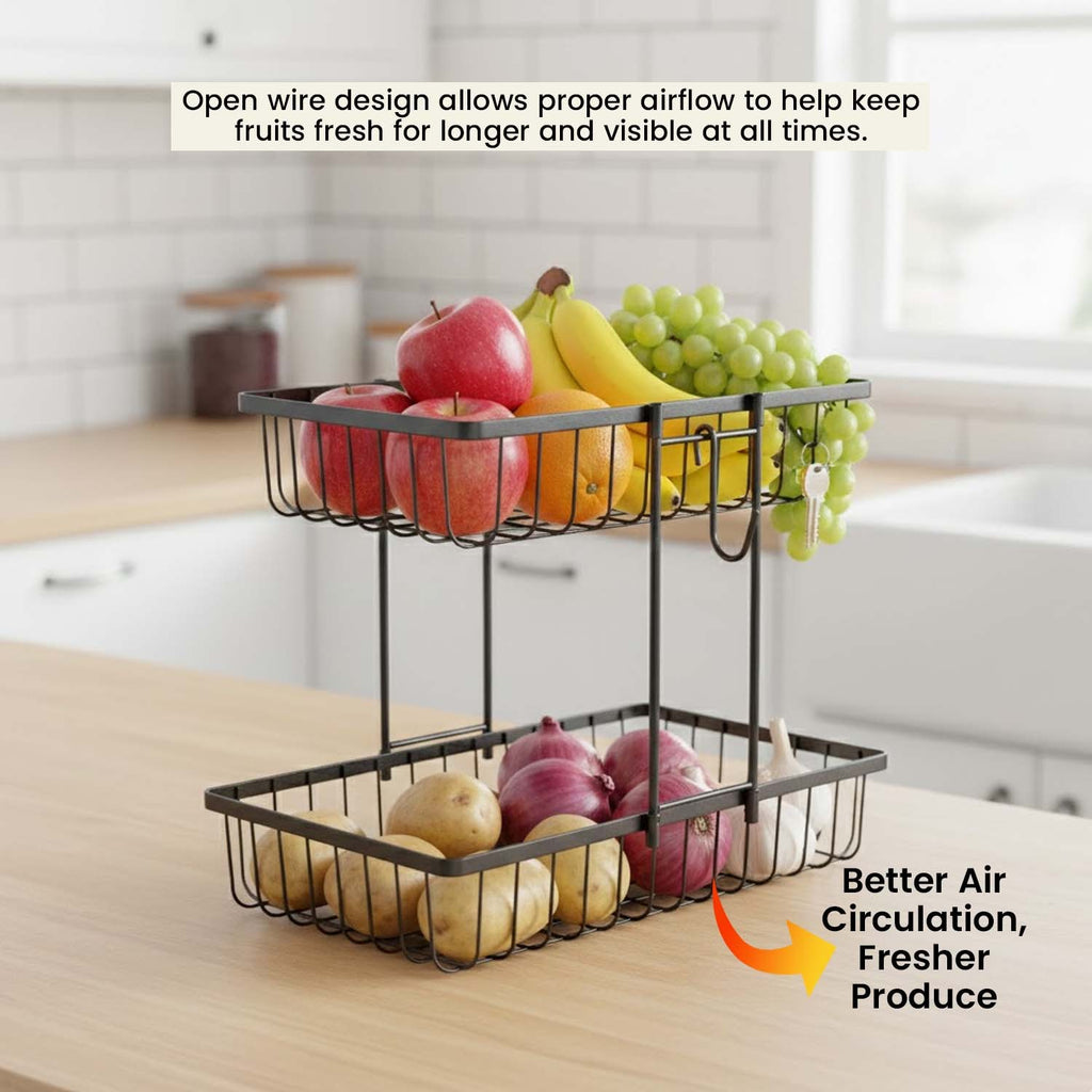GoHooked 2-tier black iron wire fruit basket on a kitchen countertop filled with fresh produce for better airflow.