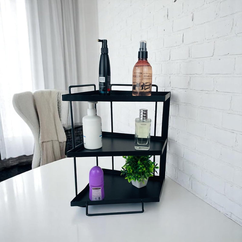 GoHooked black 3-tier iron countertop organizer rack with toiletries and a small plant.