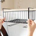 GoHooked black powder-coated iron under cabinet storage basket with grid design and hanging hooks.