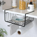 GoHooked black powder-coated iron under cabinet storage basket holding plates and a bowl, with a towel and plastic wrap below.