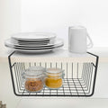 GoHooked black powder-coated iron under-shelf basket with two jars of spices. Stacked plates and mugs on shelf above.