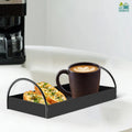 Go Hooked black iron vanity tray with handles, holding a coffee mug and two pieces of garlic bread.