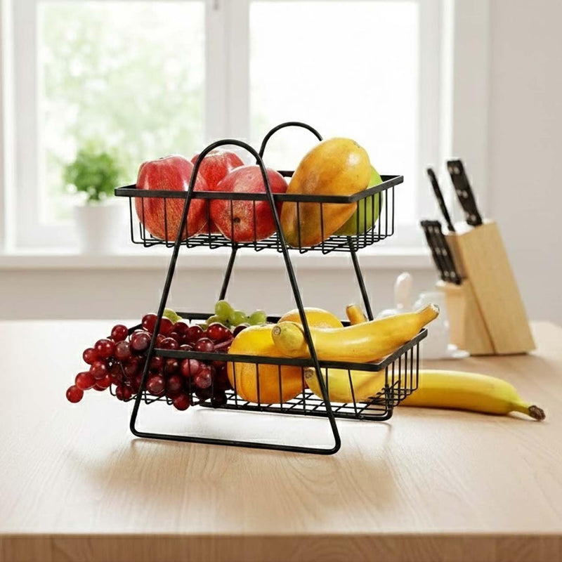 GoHooked black metal 2-tier fruit basket with apples, mango, grapes, and bananas on a wooden table.