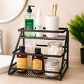 GoHooked black metal 2-tier standing rack organizer with hand wash, spray, toothbrushes, cotton swabs, jars, and candle.