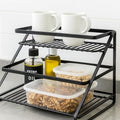GoHooked black metal 2-tier standing rack organizer with spices, oil bottles, and food containers.