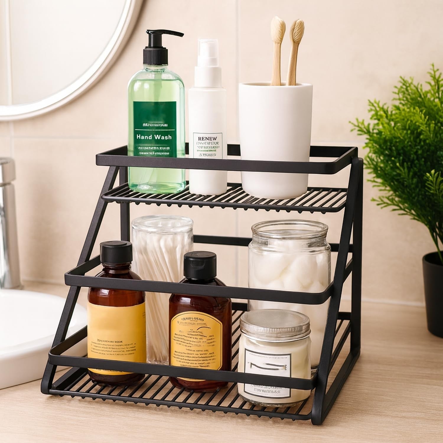 GoHooked black metal 2-tier standing rack organizer holding hand wash, spray, toothbrushes, cotton swabs, and jars.