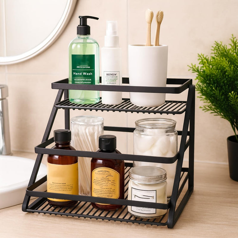 GoHooked black metal 2-tier standing rack organizer holding hand wash, spray, toothbrushes, cotton swabs, and jars.