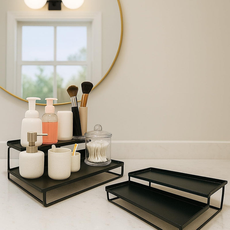 Go Hooked black metal 2-tier standing organizer with bathroom essentials like soap, cotton swabs, and makeup brushes.