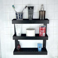 GoHooked black metal 3-tier bathroom shelf rack holding toiletries, toothpaste, and soap dispenser.