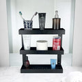 GoHooked black metal 3-tier bathroom shelf rack holding toiletries, toothpaste, and soap dispenser.