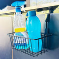 GoHooked black metal under shelf cabinet organiser basket holding cleaning spray and blue water bottle.