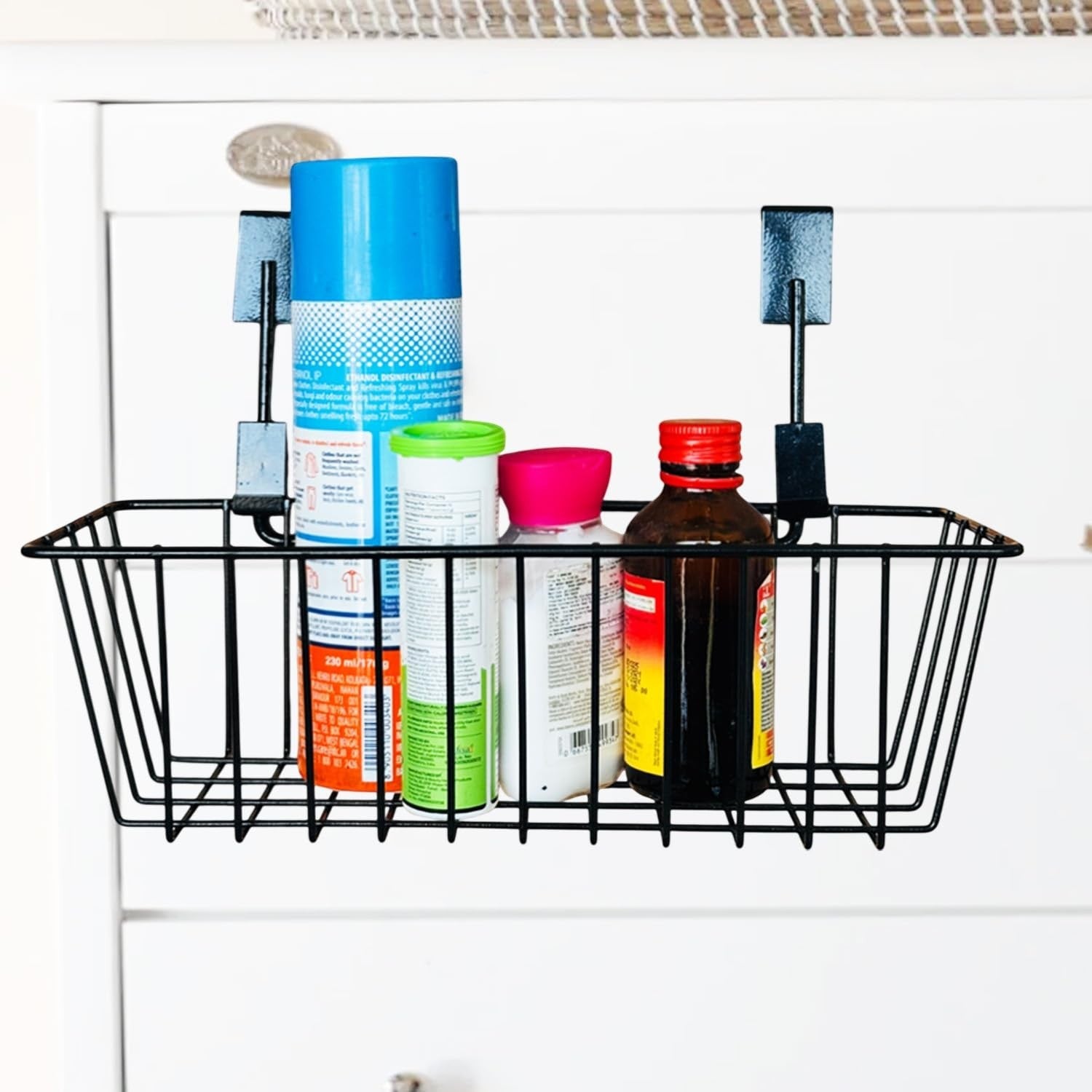 GoHooked black metal wire cabinet door organizer basket holding cleaning supplies and bottles.