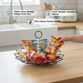Go Hooked black metal fruit basket with diamond wire design and detachable wooden bead handle, holding snacks.