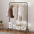 GoHooked black metal garment rack with hanging clothes and bottom shelf holding storage boxes and shoes.