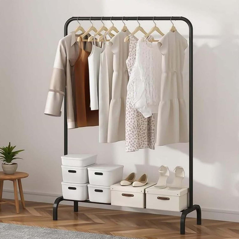 GoHooked black metal garment rack with hanging clothes and bottom shelf holding storage boxes and shoes.