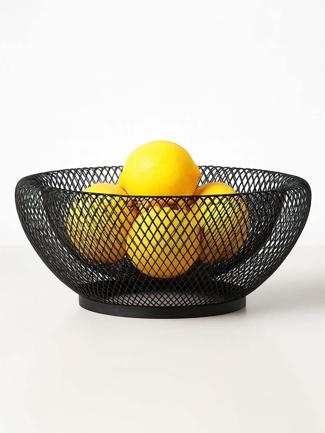 GoHooked black double-layer metal mesh fruit bowl holding fresh yellow lemons on a white background
