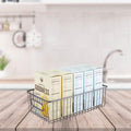 GoHooked black metal farmhouse pantry basket with wire grid design and handles, holding boxes of food.