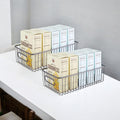 GoHooked black metal wire grid pantry organizer bins with handles, set of 2, holding boxes of food mix.