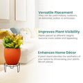 Go Hooked black metal plant pot stand holding an orange pot with a green plant, perfect for indoor or outdoor use.
