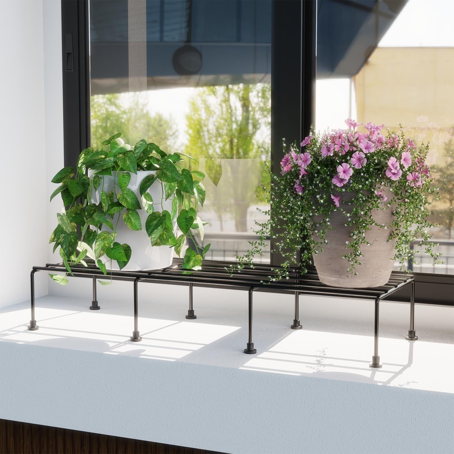 GoHooked black metal rectangular plant stand holding two potted plants on a windowsill.