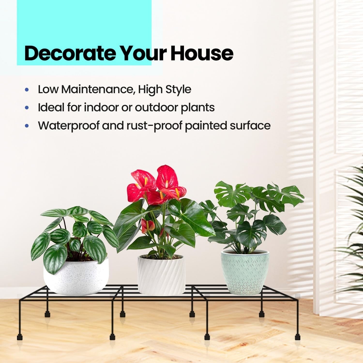 GoHooked black metal rectangular plant stand holding three potted plants indoors. Features rust-proof finish.