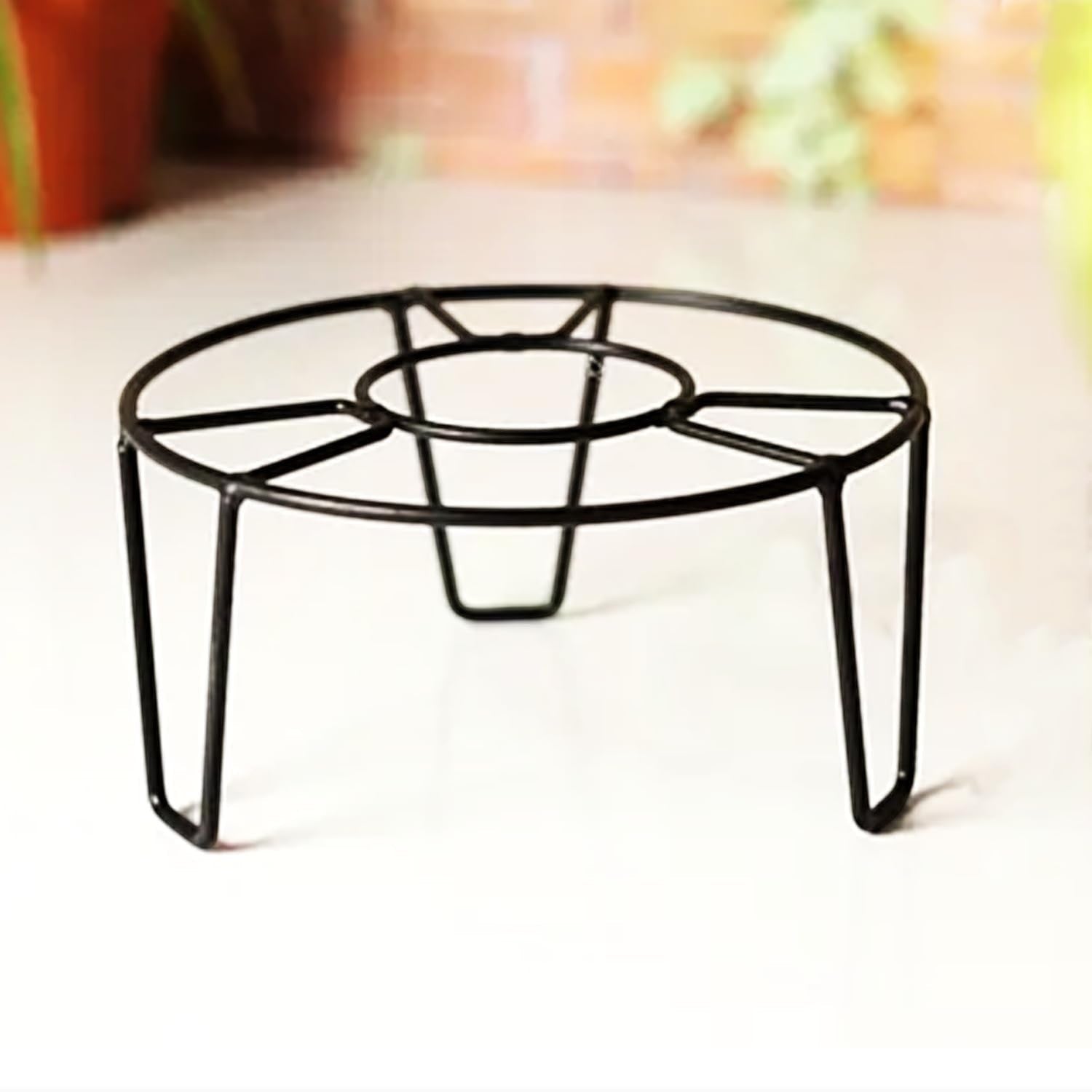 GoHooked black metal round flower pot stand with curved legs, 8-inch diameter, for indoor or outdoor use.