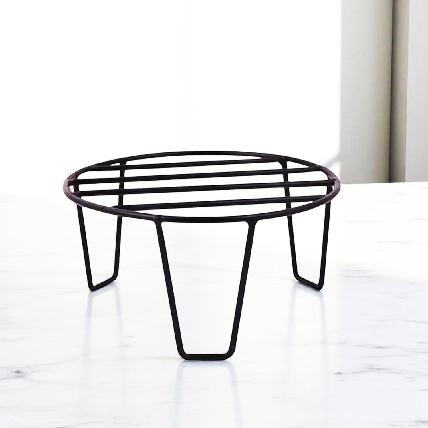 GoHooked black metal plant stand with a round slatted top and three sturdy legs, perfect for indoor or outdoor use.