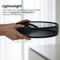 GoHooked black metal revolving fruit basket with a perforated design, perfect for countertop storage.